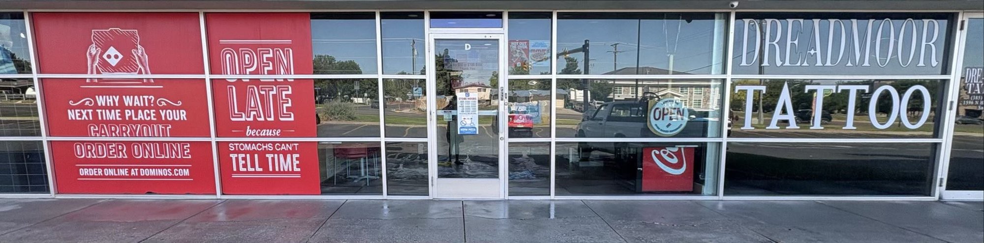 Clean storefront windows and entry on a local shop maintained by Dirt Gone Wash Co