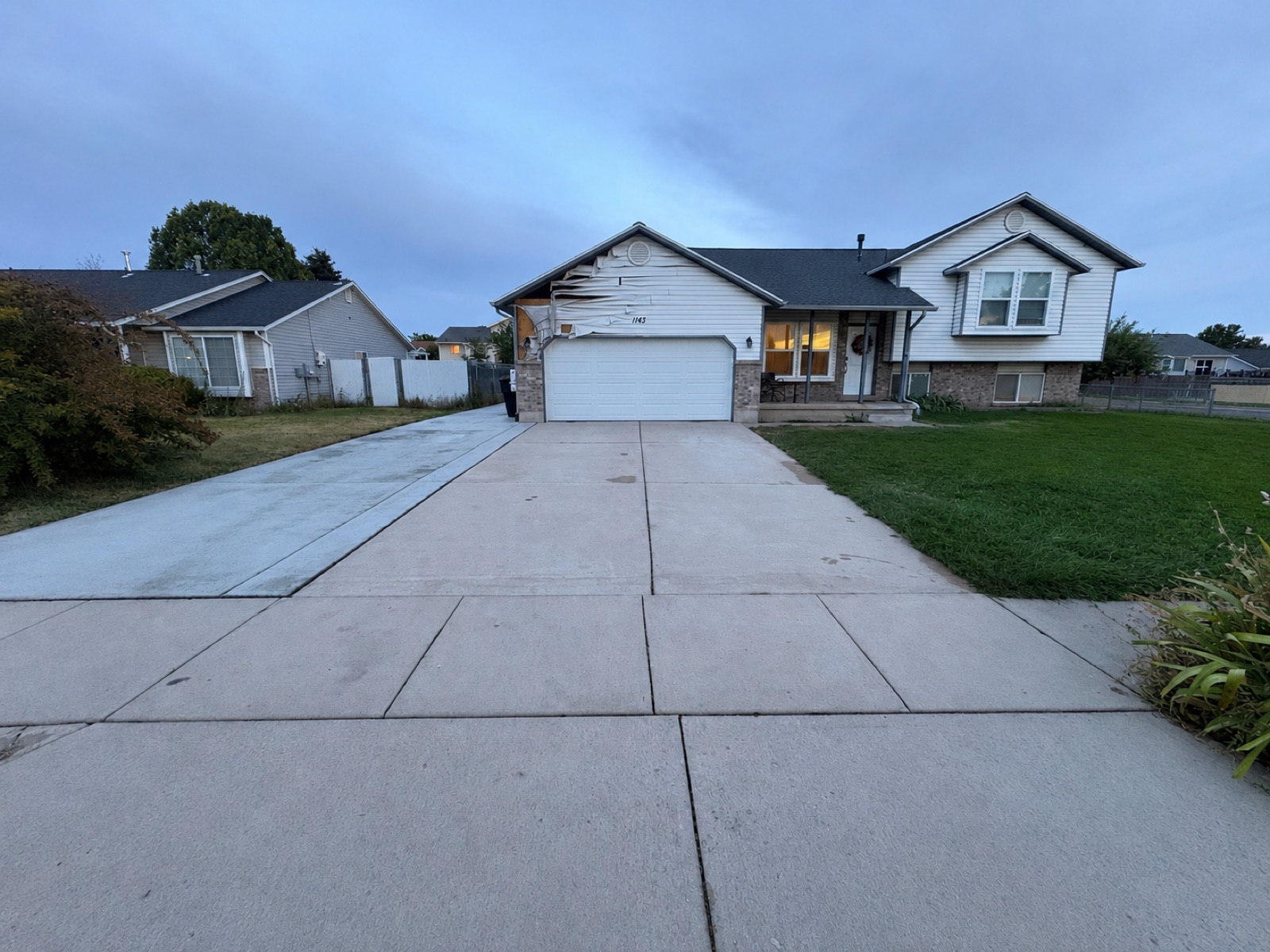 Freshly cleaned concrete driveway in front of a Salt Lake City home
